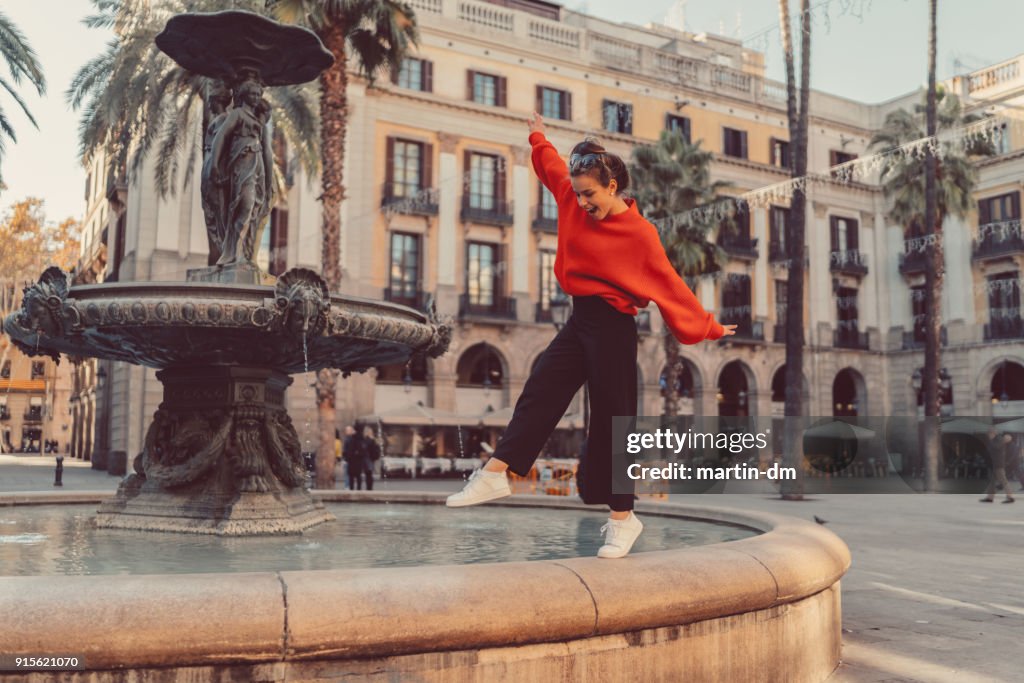 Girl standing on tip toes at the fountain
