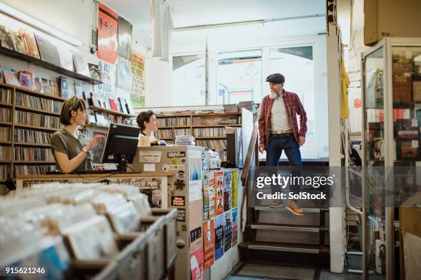 walking into a local record store - loja de música imagens e fotografias de stock