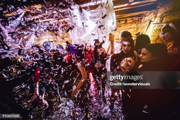 young people celebrating halloween at halloween themed party - disco costume stock pictures, royalty-free photos & images