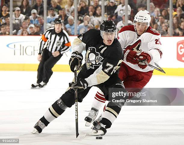 Evgeni Malkin of the Pittsburgh Penguins moves the puck up ice in front of Lauri Korpikoski of the Phoenix Coyotes on October 7, 2009 at Mellon Arena...