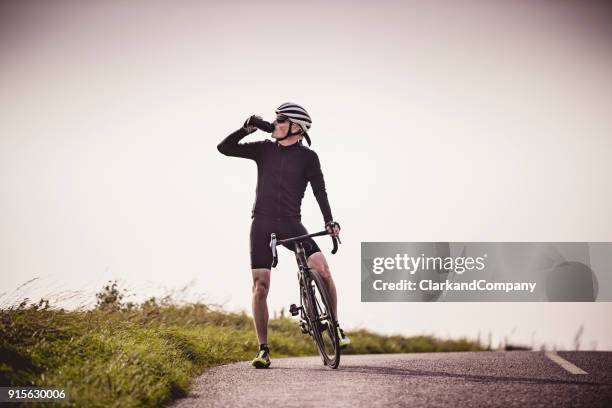 cyclist out on a training ride - spandex stock pictures, royalty-free photos & images