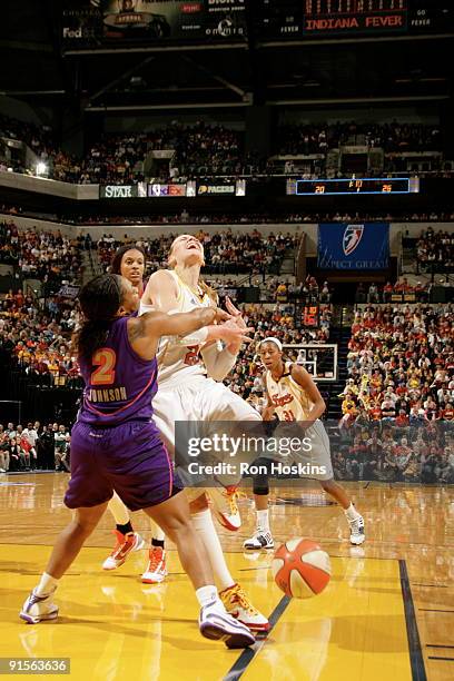 Katie Douglas of the Indiana Fever is fouled by Temeka Johnson of the Phoenix Mercury during Game Four of the WNBA Finals on October 7, 2009 at...