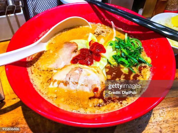 miso ramen served in red bowl on table - miso ramen stock pictures, royalty-free photos & images