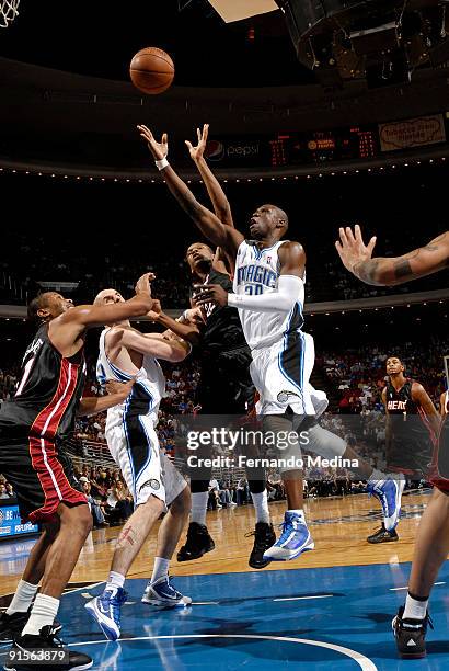 Mickael Pietrus of the Orlando Magic shoots against James Jones of the Miami Heat during the pre-season game on October 7, 2008 at Amway Arena in...