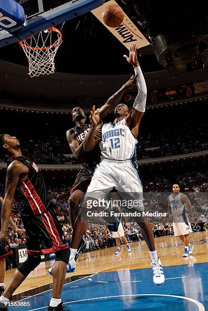 Dwight Howard of the Orlando Magic shoots against Joel Anthony of the Miami Heat during the pre-season game on October 7, 2008 at Amway Arena in...