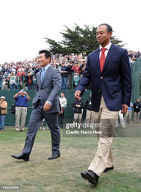 Tiger Woods of Team USA and Y. E. Yang of the International Team makes their way to the stage during Opening Ceremony of The Presidents Cup at...