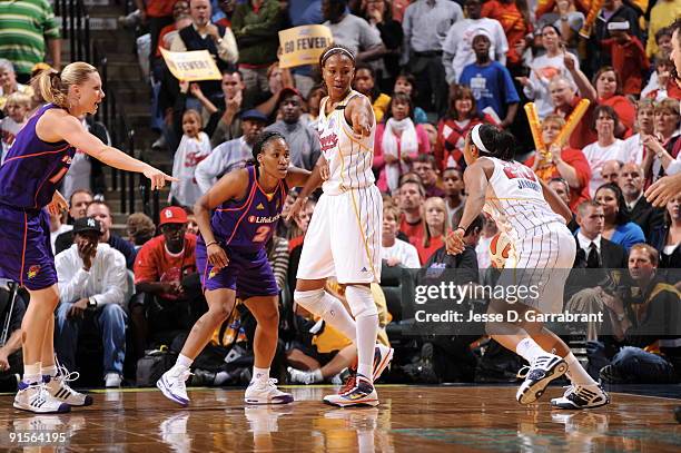 Tamika Catchings of the Indiana Fever calls a aplay against Temeka Johnson of the Phoenix Mercury during Game Four of the WNBA Finals on October 7,...