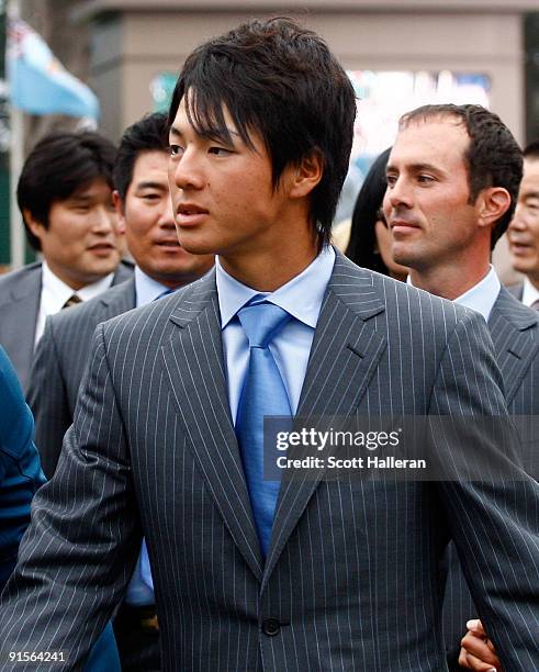 Ryo Ishikawa of the International Team walks off the stage alongside his teammates and guests during the Opening Cermonies prior to the start of The...