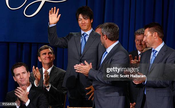 Ryo Ishikawa of the International Team waves to the gallery on the stage during the Opening Cermonies prior to the start of The Presidents Cup at...