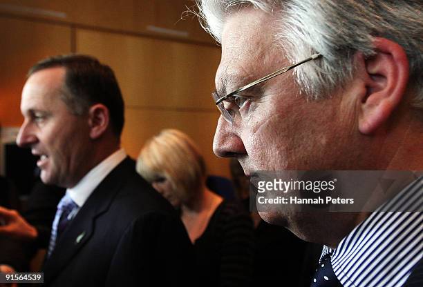 Associate Health Minister Peter Dunne listens as New Zealand Prime Mininster John Key speaks to the media about the government's new...