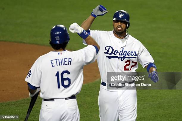 Matt Kemp of the Los Angeles Dodgers celebrates with Andre Ethier after Kemp hits a two-run home run in the first inning against the St. Louis...