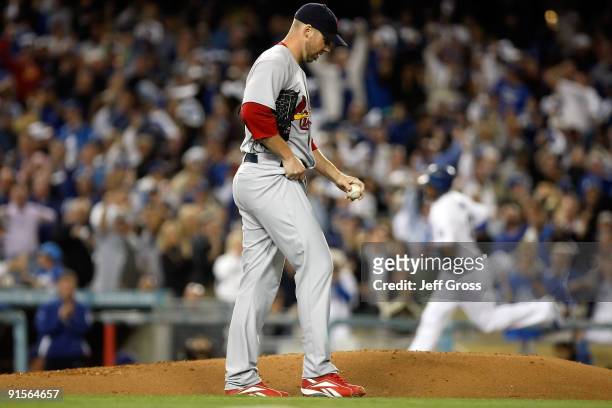 Pitcher Chris Carpenter of the St. Louis Cardinals looks down after giving up a two-run home run to Matt Kemp of the Los Angeles Dodgers in the first...