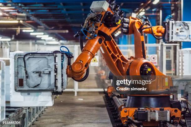 robotic arms working on assembly line - appliance manufacturing stock pictures, royalty-free photos & images