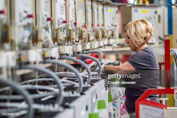 factory worker working on production line - appliance manufacturing stock pictures, royalty-free photos & images