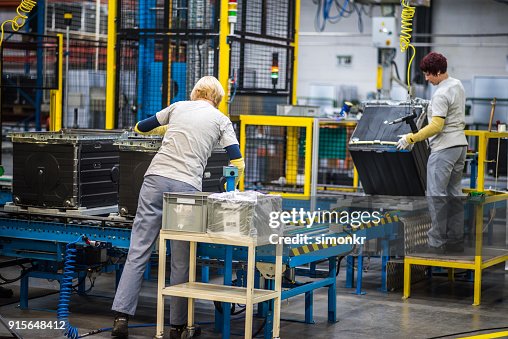 Factory Workers Working On Production Line High-Res Stock Photo - Getty ...