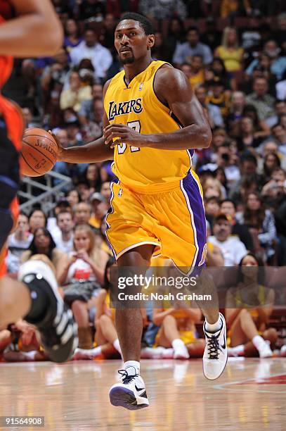 Ron Artest of the Los Angeles Lakers brings the ball up court against the Golden State Warriors during a pre-season game at Honda Center on October...