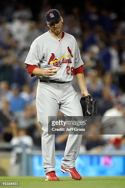 Pitcher Chris Carpenter of the St. Louis Cardinals looks down at the ball in the first inning against the Los Angeles Dodgers in Game One of the NLDS...