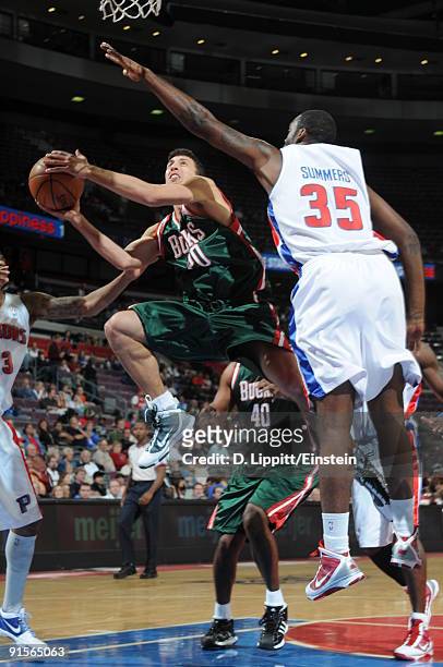 Roko Ukic of the Milwaukee Bucks goes up for a shot attempt against DaJuan Summers of the Detroit Pistons in a preseason game at the Palace of Auburn...
