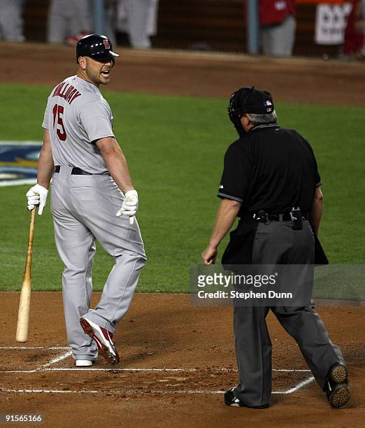 Matt Holliday of the St. Louis Cardinals argues a called third strike with home plate umpire Dana DeMuth while the bases were loaded in the first...