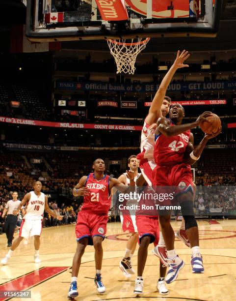 Elton Brand of the Philadelphia 76ers gets challenged under the basket by Andrea Bargnani of the Toronto Raptors on October 7, 2009 at the Air Canada...