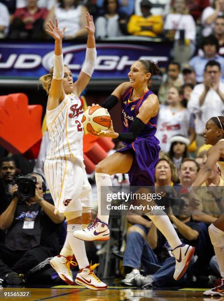 Diana Taurasi of the Phoenix Mercury passes the ball while defended by Katie Douglas of the Indiana Fever during the WNBA Finals game 4 at Conseco...