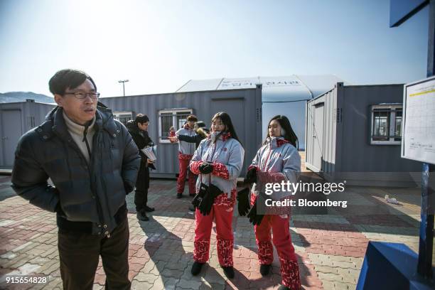 Visitor, left, looks on as he waits for a 2018 PyeongChang Winter Olympic Games shuttle bus at the Daegwallyeong Transport Mall in the Hoenggye-ri...