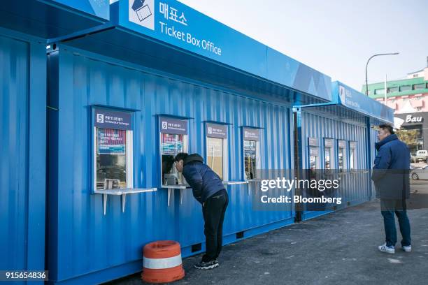 Visitor speaks with an employee at the ticket box offices ahead of the 2018 PyeongChang Winter Olympic Games in the Hoenggye-ri village area of...