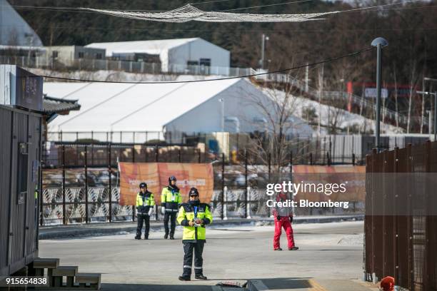 Police officers stand guard near the PyeongChang Olympic Plaza ahead of the 2018 PyeongChang Winter Olympic Games in the Hoenggye-ri village area of...