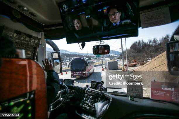 Bus driver waves while driving a shuttle bus for the 2018 PyeongChang Winter Olympic Games in the Hoenggye-ri village area of Pyeongchang, Gangwon...