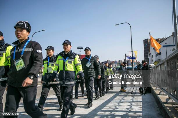 Police officers march along a road ahead of the 2018 PyeongChang Winter Olympic Games in the Hoenggye-ri village area of Pyeongchang, Gangwon...