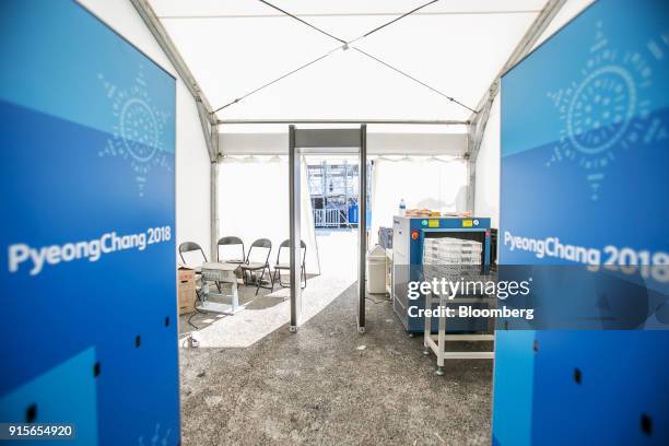 Metal detector and a luggage scanner stands at a security check point inside a tent at the entrance to the PyeongChang Olympic Plaza ahead of the...