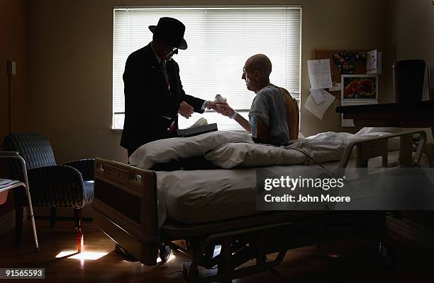 Terminally ill patient Jim Staloch , caresses a dove on October 7, 2009 while at the Hospice of Saint John in Lakewood, Colorado. Animal therapist...