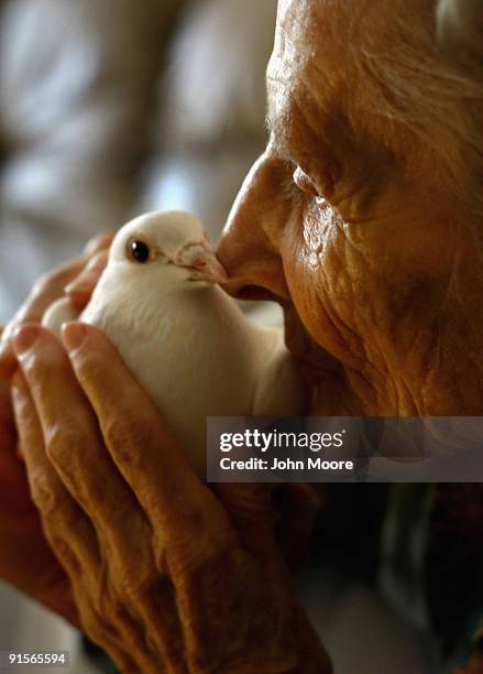 Terminally ill patient Jackie Beattie holds a dove on October 7, 2009 while at the Hospice of Saint John in Lakewood, Colorado. The dove releases are...