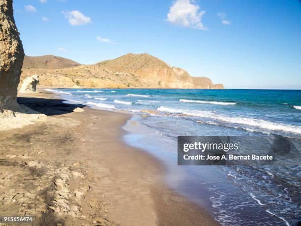 coast line with cliffs and beaches with water waves in movement. cabo de gata - nijar natural park, beach of the white crag, isleta of the moor, biosphere reserve, almeria,  andalusia, spain. - biosphere planet earth stock pictures, royalty-free photos & images