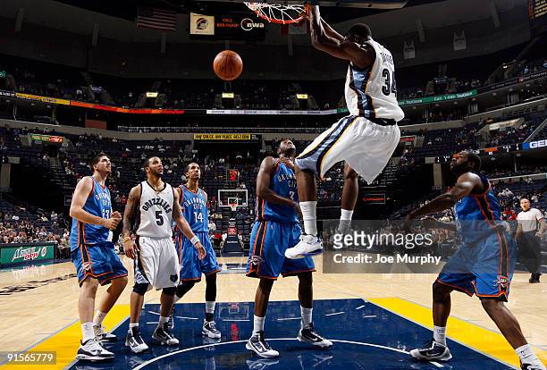 Hasheem Thabeet of the Memphis Grizzlies dunks the ball against DJ White of the Oklahoma City Thunder on October 7, 2009 at at FedExForum in Memphis,...