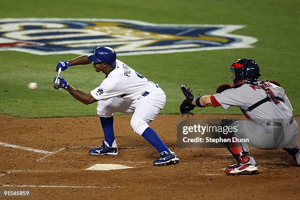 Juan Pierre of the Los Angeles Dodgers lays down a sacrifice bunt in the fifth inning against the St. Louis Cardinals in Game One of the NLDS during...