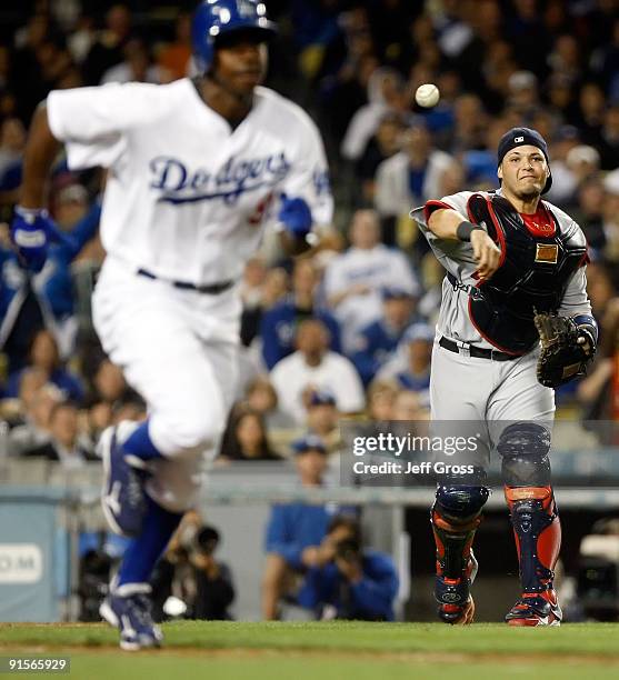 Catcher Yadier Molina of the St. Louis Cardinals throws out Juan Pierre of the Los Angeles Dodgers at first base as Pierre had a sacrifice bunt in...