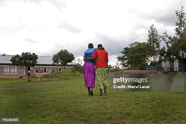 Young girls walk in arms on the grounds of the Tasaru Safehouse for Girls December 21, 2006 in Narok, Kenya. The Tasaru Safehouse supports board,...