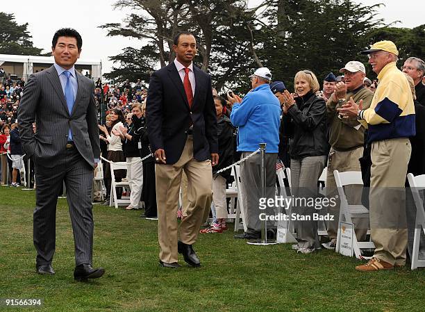 Yang, left, and Tiger Woods, right, enter the opening ceremonies during The Presidents Cup at Harding Park Golf Club on October 7, 2009 in San...