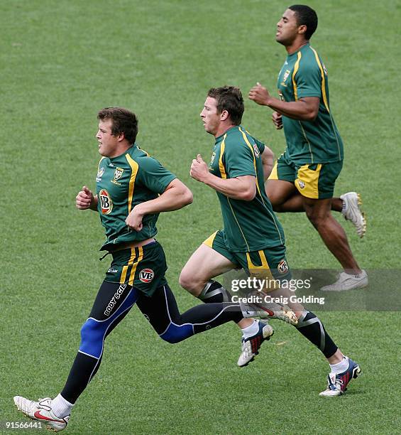 Josh Morris, Kurt Gidley and Michael Jennings run during an Australian Kangaroos training session at Concord Oval on October 8, 2009 in Sydney,...