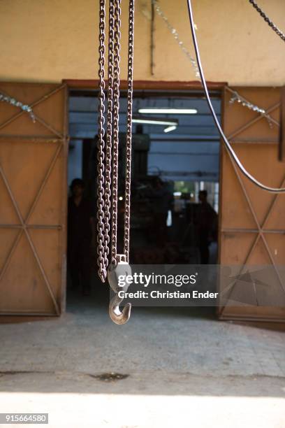 Pune, India A shot of a metal hook hanging outside of the factory building in the technical institute on April 23, 2013 in Pune, India.