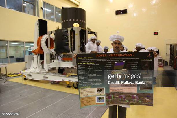 Displaying the poster on Chandrayaan-2 near the satellite. The Indian Space Research Organisation or ISRO is putting finishing touches to India's...