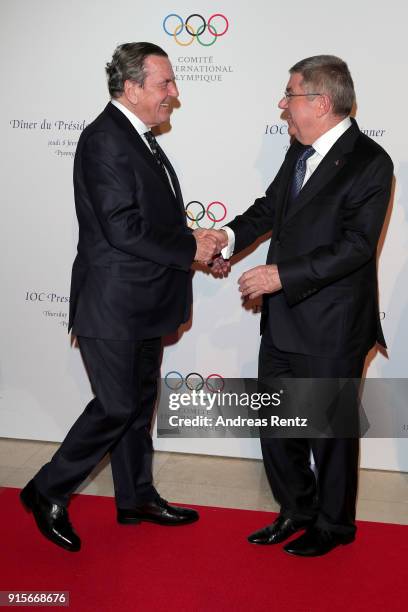 President Thomas Bach greets Former Chancellor of Germany Gerhard Schroder during the IOC President's Dinner ahead of the PyeongChang 2018 Winter...