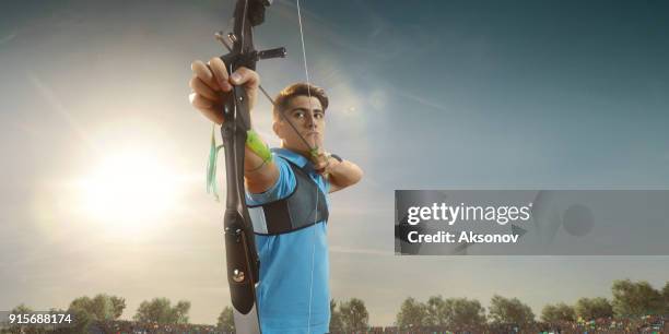 male archer shooting with the longbow at sunset - archery range stock pictures, royalty-free photos & images