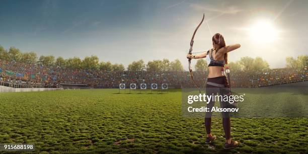 female archer shooting with the longbow at sunset - archery range stock pictures, royalty-free photos & images