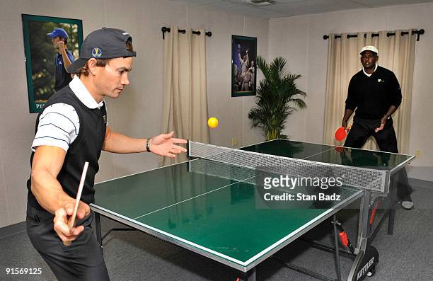 International team members Camilo Villegas, left, and Vijay Singh, right, play ping-pong after their practice round for The Presidents Cup at Harding...