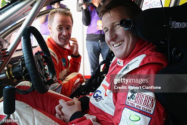 Mark Skaife, driver of the Sprint Gas Raing Team, talks with co-driver Greg Murphy prior to practice for the Bathurst 1000, which is round 10 of the...
