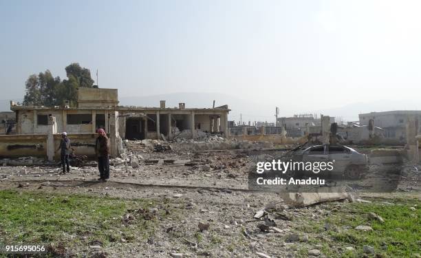 Wreckages of buildings and a car are seen after Russian airstrikes hit Mishmishan village of Idlib's Jisr al-Shughur district in Syria on February...