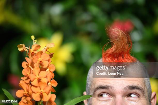 Florist Hank Roling poses with a Vanda orchid during a press preview of the Thai Orchid Festival at Kew Gardens on February 8, 2018 in London,...