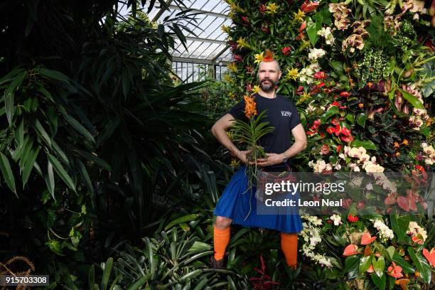 Florist Hank Roling poses with a Vanda orchid during a press preview of the Thai Orchid Festival at Kew Gardens on February 8, 2018 in London,...